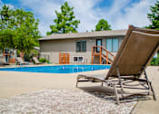 Thumbnail 29 of 35 - A chair is on the ground next to a pool.
