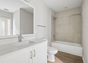Thumbnail 12 of 71 - A white bathroom with a sink, toilet, and bathtub.