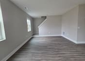 Thumbnail 29 of 57 - Townhome living area and stairs leading to second level at Flats at Sugar Run Apartments, Delaware, 43015