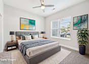 Thumbnail 28 of 30 - A bedroom with a large bed and a ceiling fan.