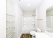 Thumbnail 20 of 31 - A white bathroom with a toilet, sink, and bathtub.at Tiffany Flats, Columbus