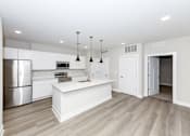 Thumbnail 19 of 31 - A kitchen with a white island and stainless steel appliances.at Tiffany Flats, Columbus, Ohio