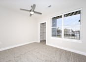 Thumbnail 13 of 31 - A room with a fan and a window with blinds.at Tiffany Flats, Columbus, 43231