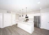 Thumbnail 10 of 31 - A kitchen with a white island and stainless steel appliances.at Tiffany Flats, Ohio, 43231