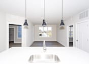 Thumbnail 12 of 31 - A modern kitchen with a large sink and pendant lights.at Tiffany Flats, Columbus
