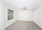 Thumbnail 18 of 31 - A room with a ceiling fan and carpeted floor.at Tiffany Flats, Columbus, OH, 43231