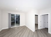 Thumbnail 16 of 31 - A room with a sliding glass door and a white door.at Tiffany Flats, Columbus, OH, 43231