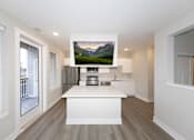 Thumbnail 6 of 31 - A modern kitchen with a large island and a mountain displayed on the wall.at Tiffany Flats, Columbus, 43231