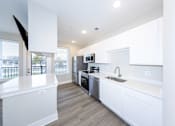 Thumbnail 1 of 31 - A modern kitchen with white cabinets and stainless steel appliances.at Tiffany Flats, Ohio, 43231
