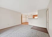 Thumbnail 40 of 41 - A room with a carpeted floor and a door on the right side.
