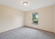 Thumbnail 41 of 41 - A room with a window and carpeted floor.