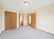 Thumbnail 15 of 41 - A room with a carpeted floor and a ceiling light.