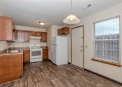 Thumbnail 17 of 21 - A kitchen with wooden cabinets and a white refrigerator.