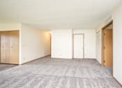 Thumbnail 24 of 24 - A room with a carpeted floor and two doors.