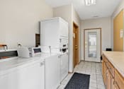 Thumbnail 24 of 26 - The clubhouse and leasing office at The Woods at McNeil Farms welcomes you! Enjoy amenities like a shared space, pool, and on-site laundry facility.