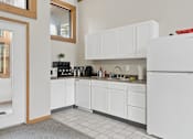 Thumbnail 25 of 26 - The clubhouse and leasing office at The Woods at McNeil Farms welcomes you! Enjoy amenities like a shared space, pool, and on-site laundry facility.