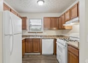 Thumbnail 1 of 28 - A fully equipped kitchen with appliances like refrigerator, stove, oven, and dishwasher, of an available home for rent at Cabot's Mill near Columbus, OH.