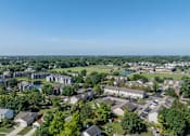 Thumbnail 34 of 35 - A bird's eye view of a residential area with houses and trees.