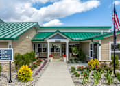 Thumbnail 37 of 57 - The front of a building with a sign that says "American Leasing Office & Clubhouse".