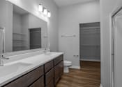 Thumbnail 54 of 57 - A bathroom with a sink, mirror, toilet and shower.