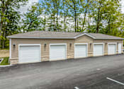 Thumbnail 31 of 57 - A two-car garage with a brick exterior and white doors.