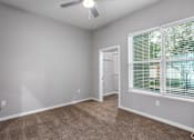 Thumbnail 41 of 57 - A room with a carpeted floor and a window with blinds.