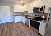 Thumbnail 3 of 16 - Kitchen and living area of an available apartment unit at Greenwood Commons Apartments in Delaware, OH.