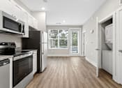 Thumbnail 1 of 33 - A kitchen with black appliances and white cabinets.