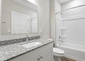 Thumbnail 10 of 33 - A bathroom with a sink, toilet, and bathtub.