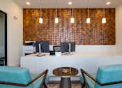 Thumbnail 45 of 49 - A reception area with a wooden wall and two chairs.at Imperial Crossing Luxury Apartment Homes, Bonita Springs, Florida