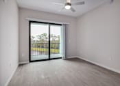 Thumbnail 26 of 49 - A room with a sliding glass door leading to a balcony.at Imperial Crossing Luxury Apartment Homes, Bonita Springs, FL, 34134