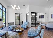 Thumbnail 47 of 49 - A living room with a blue chair and a coffee table.at Imperial Crossing Luxury Apartment Homes, Florida