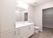 Thumbnail 27 of 49 - A white bathroom with a toilet, sink, and mirror.at Imperial Crossing Luxury Apartment Homes, Bonita Springs, FL, 34134