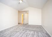 Thumbnail 12 of 17 - A room with a carpeted floor and a ceiling fan.
