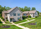 Thumbnail 3 of 17 - A residential area with houses and green lawns.