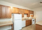 Thumbnail 23 of 23 - A kitchen with wooden cabinets and white appliances.