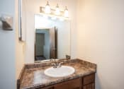 Thumbnail 31 of 32 - a bathroom with a sink and a mirror