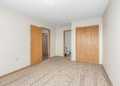 Thumbnail 9 of 30 - Carpeted bedroom, closet, and attached bathroom of a River Valley apartment home in Lancaster, OH.