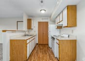 Thumbnail 7 of 30 - Kitchen of a River Valley apartment home in Lancaster, OH, with cabinets, stove, oven, refrigerator.