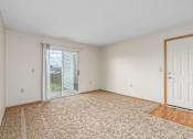 Thumbnail 1 of 30 - Main living area of a River Valley apartment home in Lancaster, OH, with carpeting, window blinds.