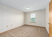 Thumbnail 20 of 30 - Carpeted bedroom and window with blinds of River Valley apartment home in Lancaster, OH.
