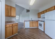 Thumbnail 1 of 27 - A kitchen with wooden cabinets and white appliances.