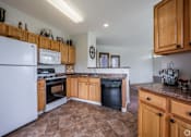 Thumbnail 6 of 27 - A kitchen with a white refrigerator and wooden cabinets.