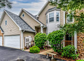 Thumbnail 7 of 27 - A house with a garage and a driveway.