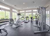 Thumbnail 8 of 36 - A spacious gym with a variety of equipment and a view of the outdoors.