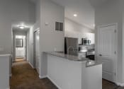Thumbnail 4 of 27 - a kitchen with a granite counter top and a stainless steel refrigerator