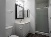 Thumbnail 13 of 27 - a small bathroom with a sink and a shower