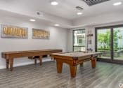 Thumbnail 5 of 53 - A room with a pool table and two paintings on the wall.