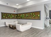 Thumbnail 47 of 53 - A living room with a green plant mural on the wall.