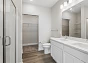 Thumbnail 54 of 71 - A white bathroom with a toilet, sink, and mirror.